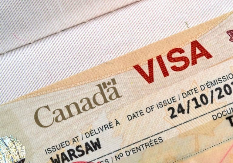 Canada visa page in a passport with issue date visible.